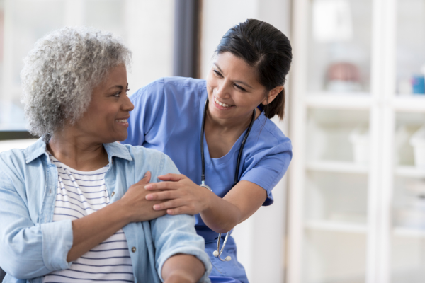 nurse comforting women with senior dental issues